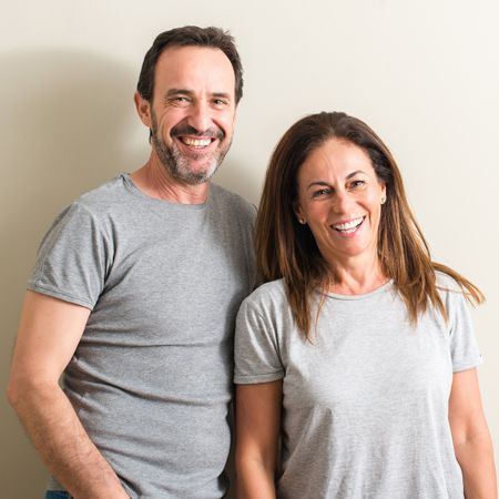 Hands holding an animated tooth and umbrella
